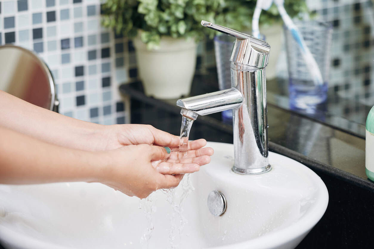 Women washing her hands in a bathroom