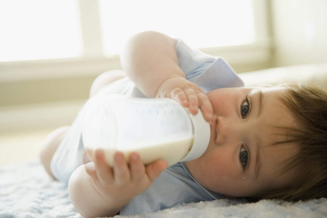 Baby drinking a bottle of milk