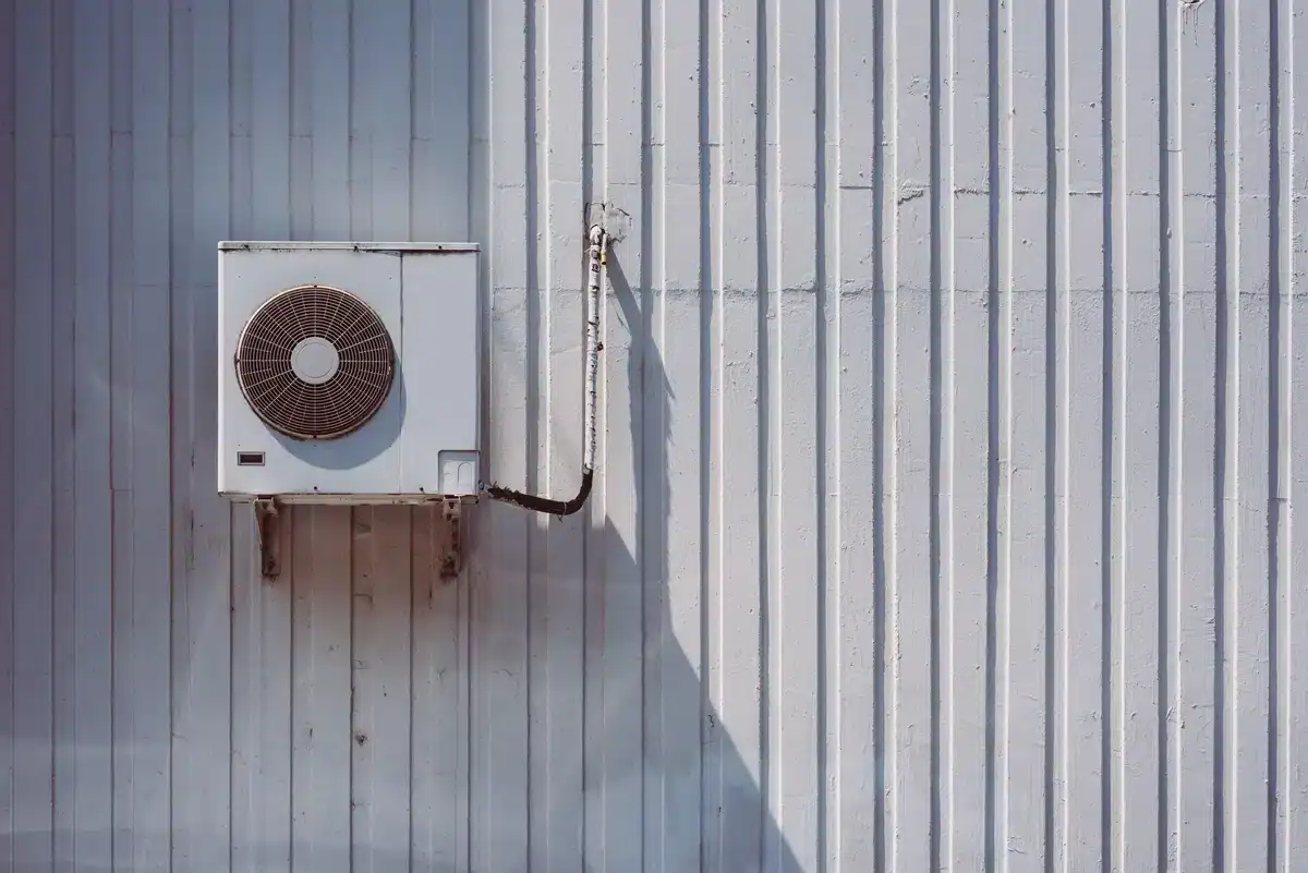 old air conditioner on wall in need of emergency repair