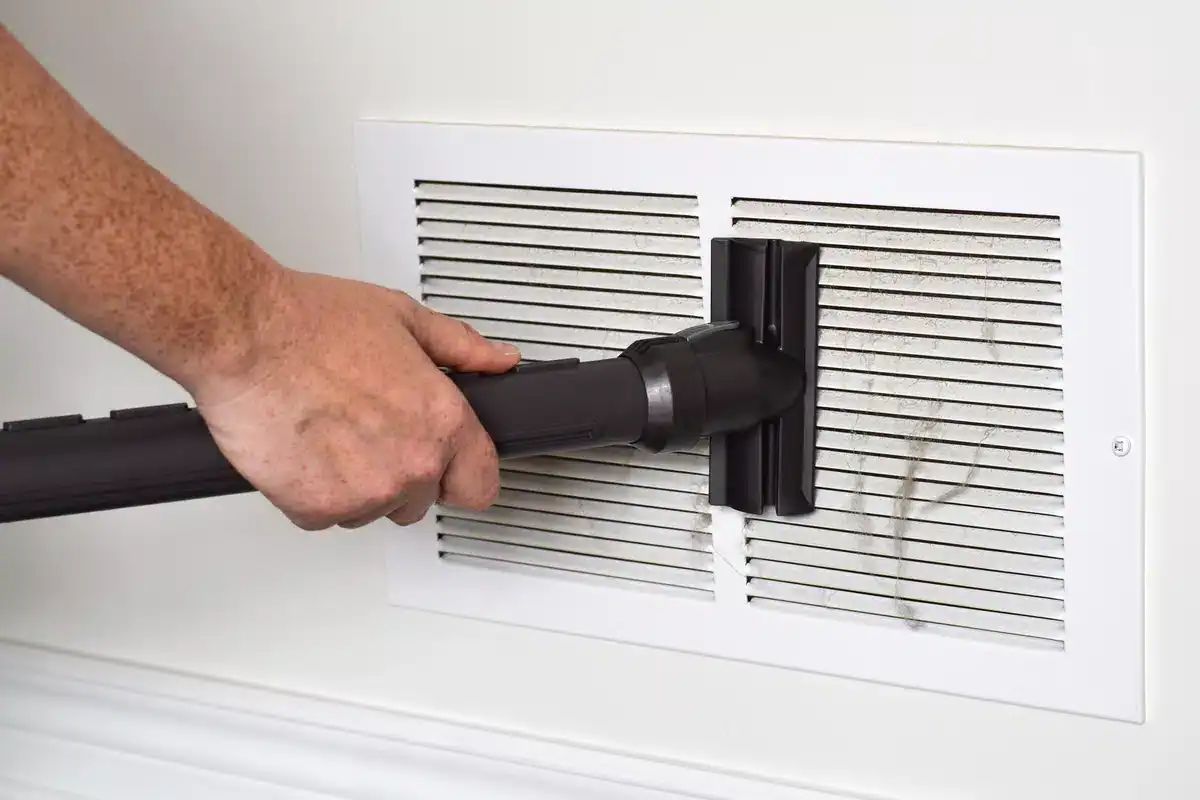 vaccuming heating vent-cleaning furnace
