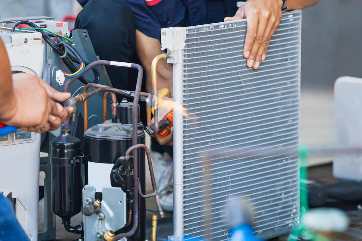 Close Up Of Air Conditioning Repair Team Use Fuel Gases And Oxygen To Weld Or Cut Metals, Oxy Fuel Welding And Oxy Fuel Cutting Processes, Repairman On The Floor Fixing Air Conditioning System
