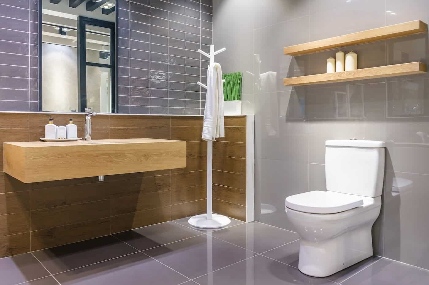 Luxury Bathroom Interior With Toilet Bowl, Mirror And Modern Basin Cabinet For Home, House, Building, Hotel, Resort