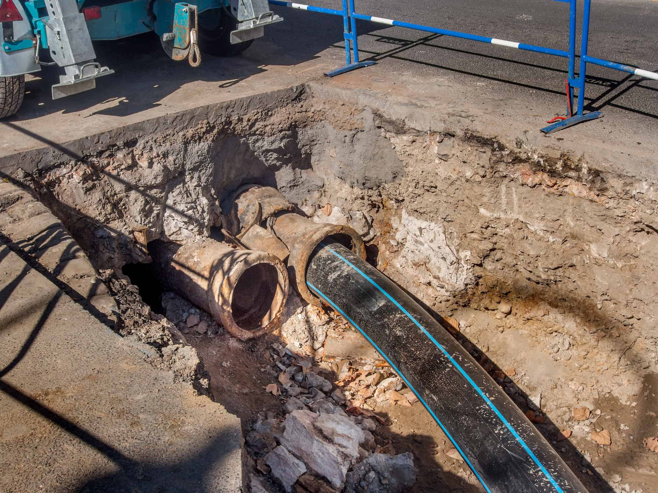 New Plastic Sewer Pipe Being Inserted Into A Broken Cast Iron Pipe.