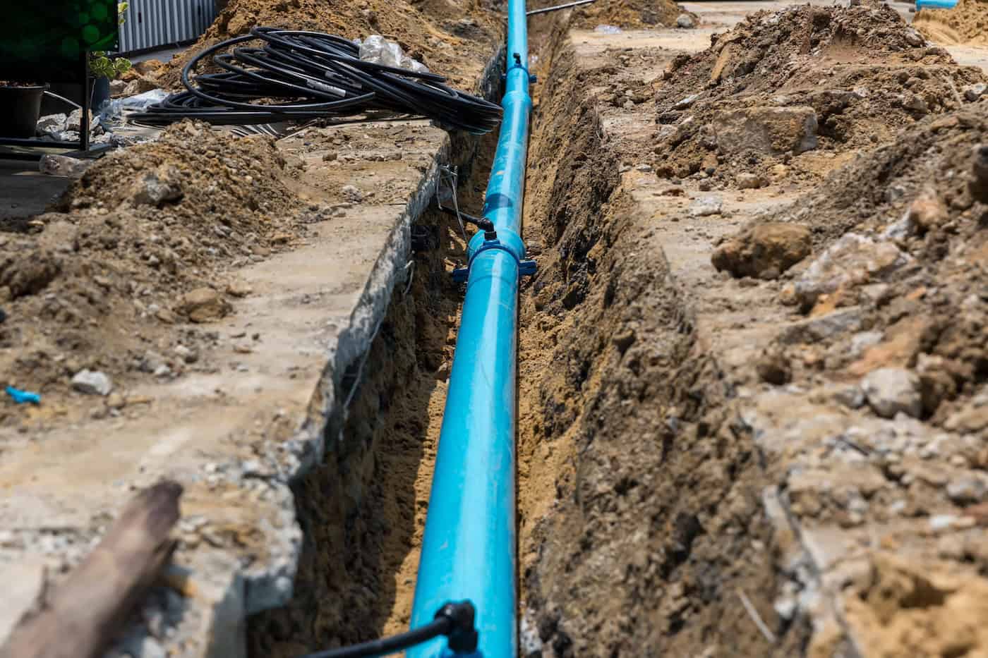 Construction Site With New Water Pipes In The Ground. Sewer Pipes To Repair Or Restore In Street City