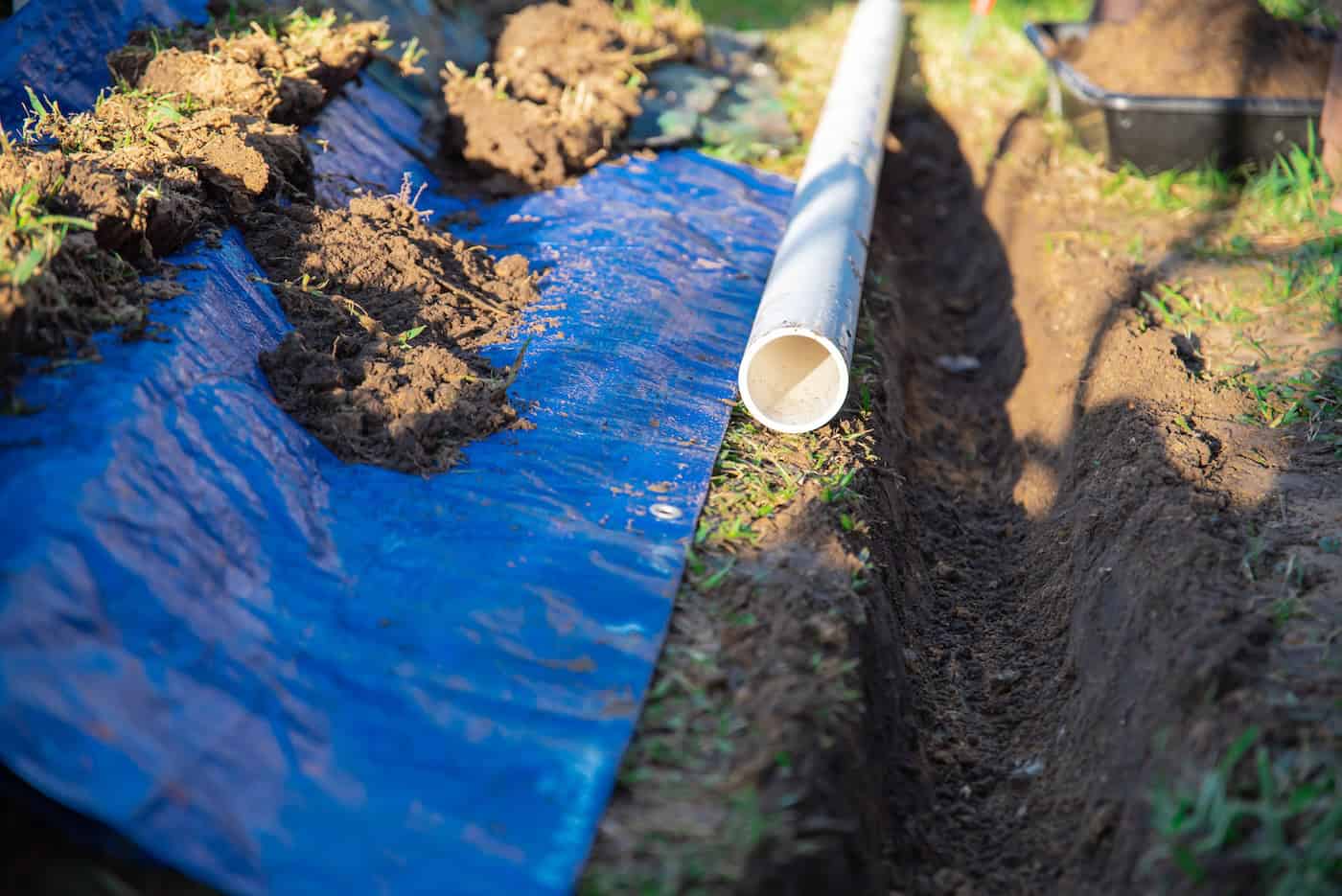 Selective Focus Plastic Sewage Pipes Pvc, Blue Tarp With Dirt, Black Mixing Tub, Pipe Ready To Laying, Buried In Ground Trench, Rainwater Drainage Residential House, Dallas, Texas, Usa