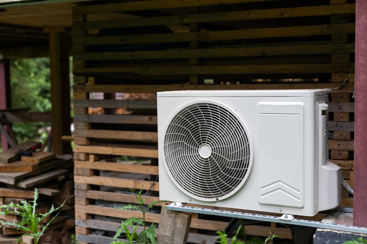 New Modern Hvac Air Conditioning External Compressor Unit Preapred For Installation Or Replacement Near Wall Of Wooden Log Residential Country Cottage. Ladder And Equipment For Service And Maintenance.