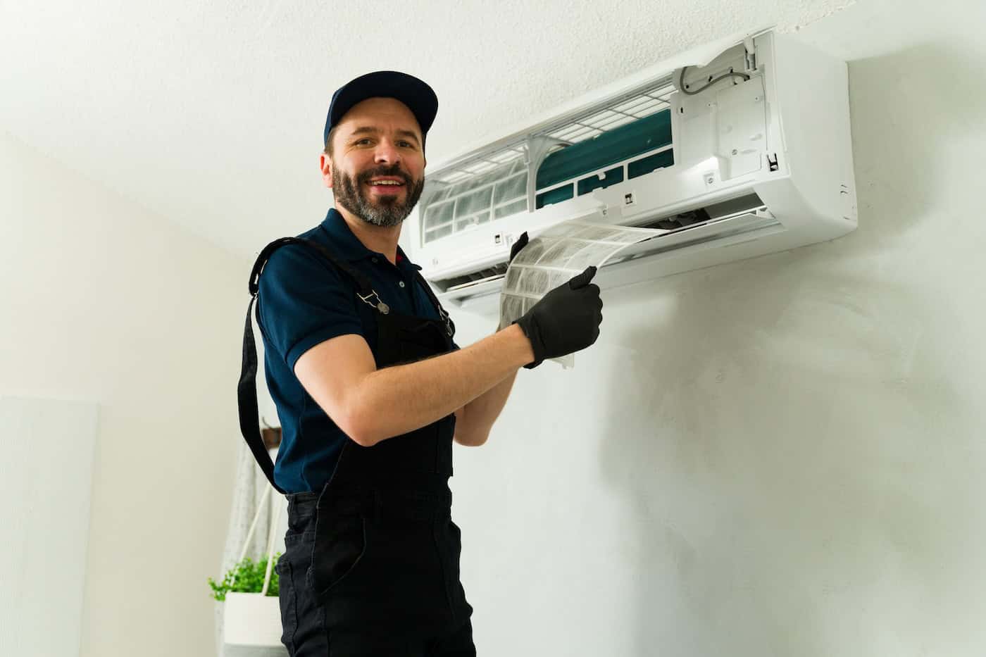 Hvac Technician Cleaning Air Conditioner Filter During Maintenance Service