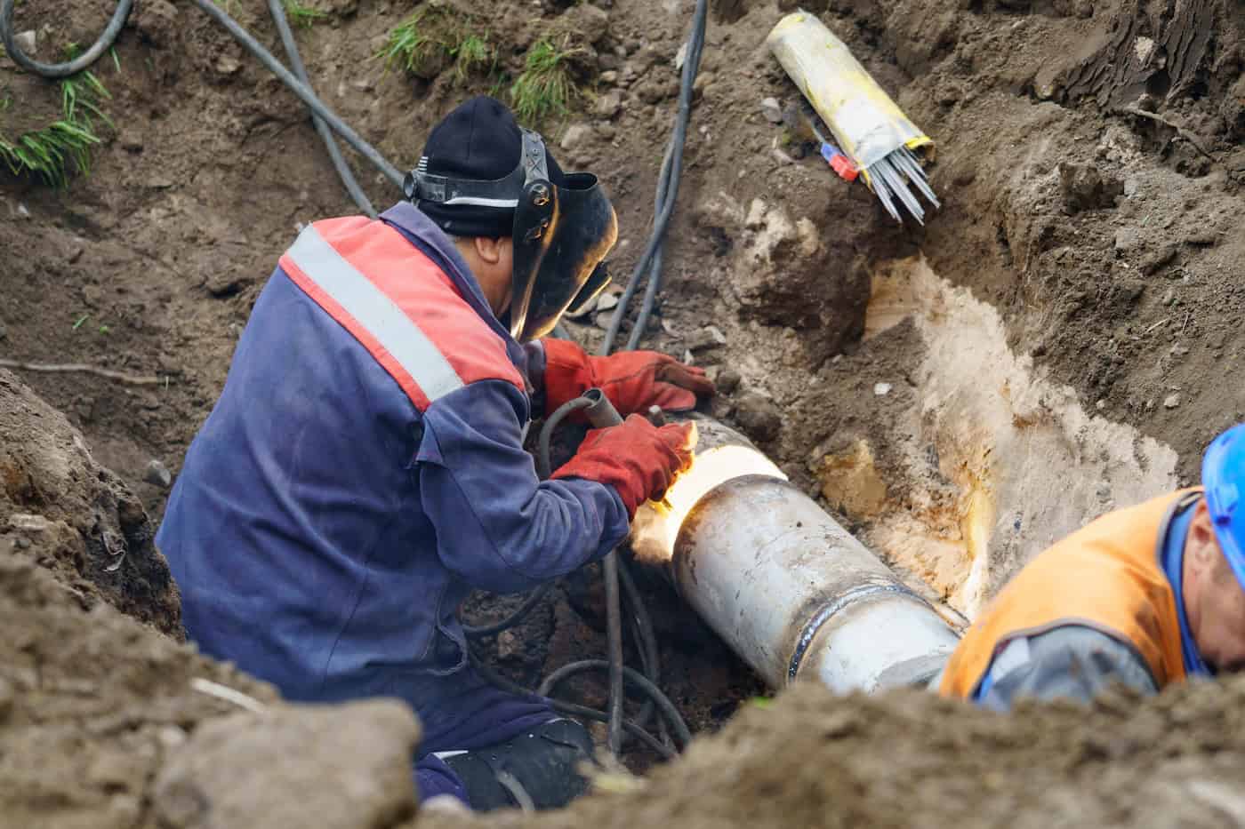 Utility Worker Fixing Broken Water Main. Sewerage Pipe Repair Concept.