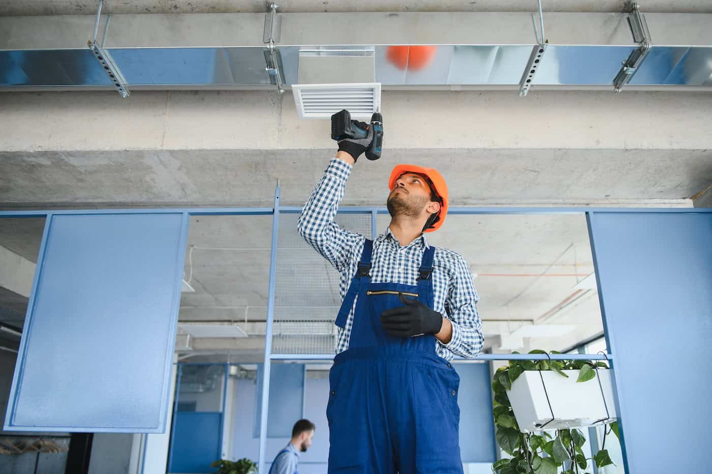 Hvac Services Worker Install Ducted Pipe System For Ventilation And Air Conditioning In House