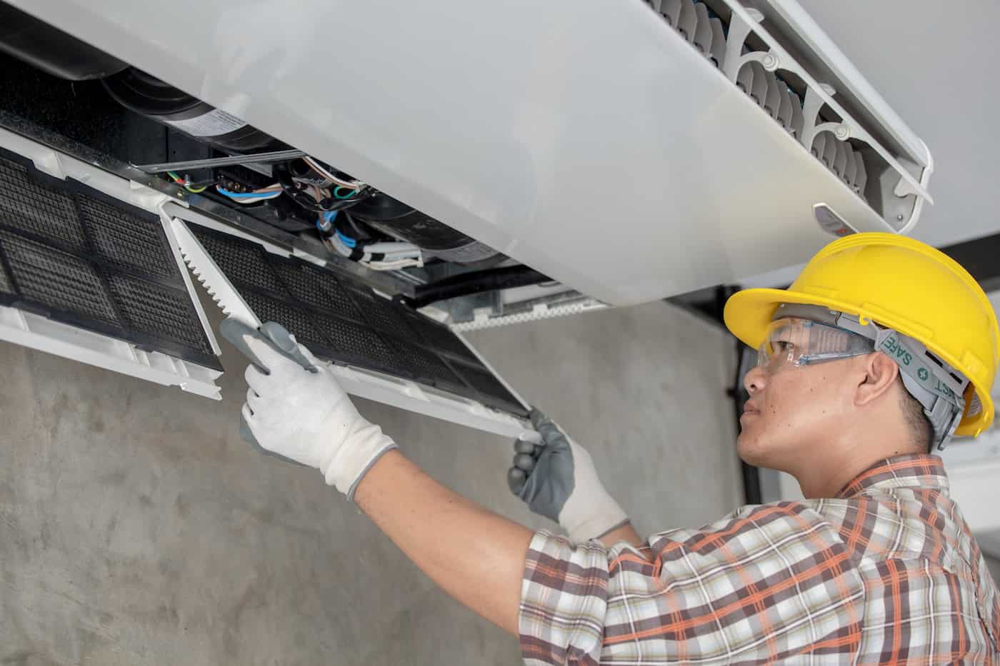 Air Conditioning Technician Repairing Air Conditioner And Install New Air Conditioner. Young Asia Repairing Air Conditioning Concept