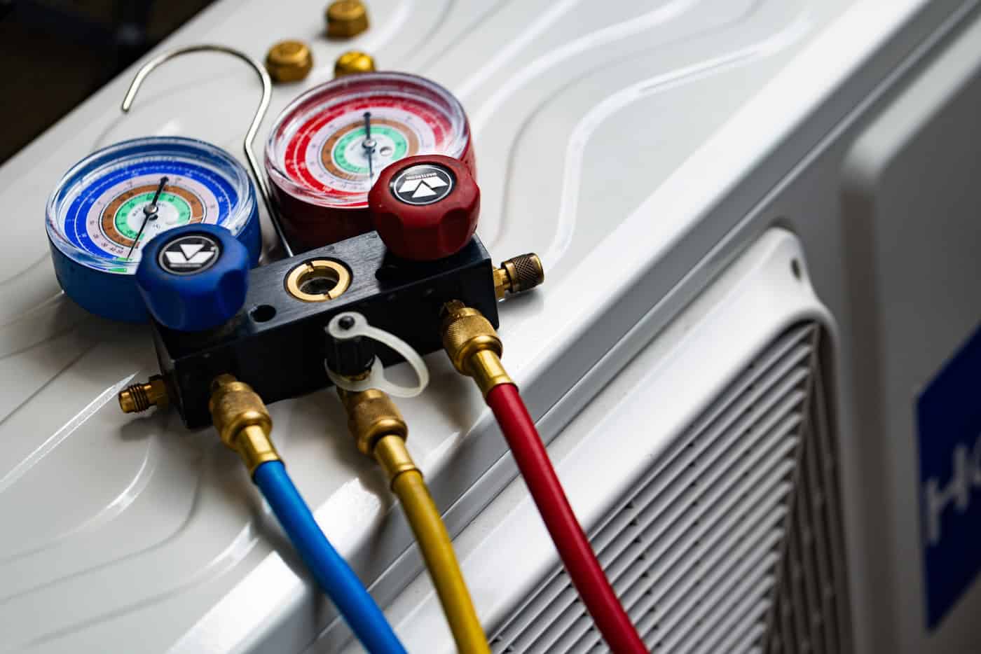 Refrigerant Manifold Gauges Connected To Ac Unit