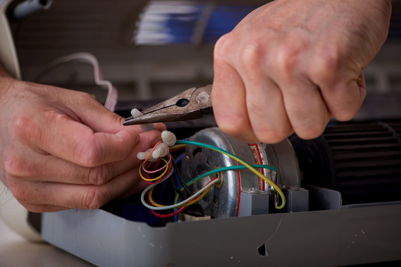 Old Repairman Repairing Air Conditioner At Workshop