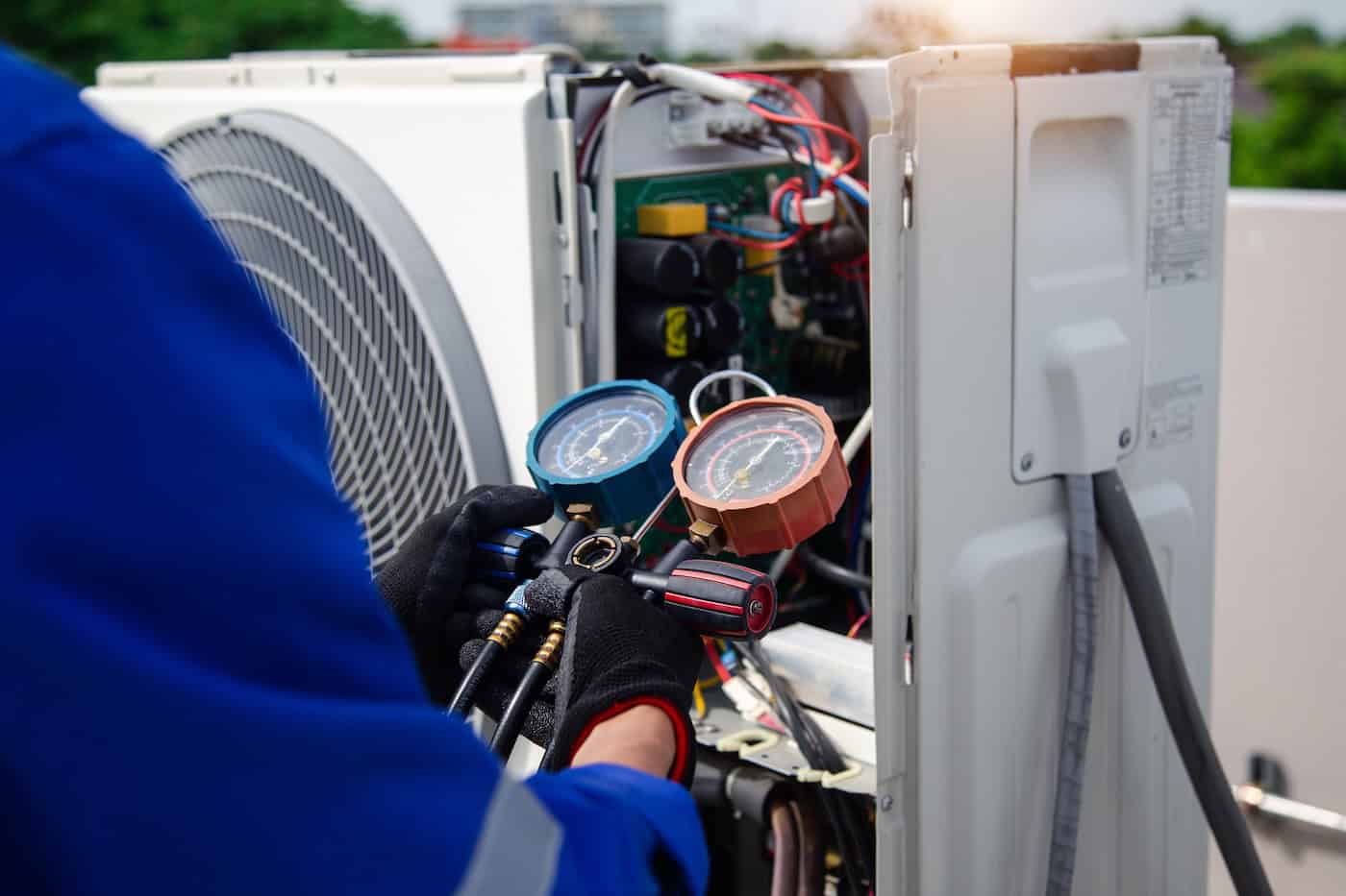 Air Conditioner Service .the Air Conditioner Technician Is Using A Gauge To Measure The Refrigerant Pressure. Air Compressor.