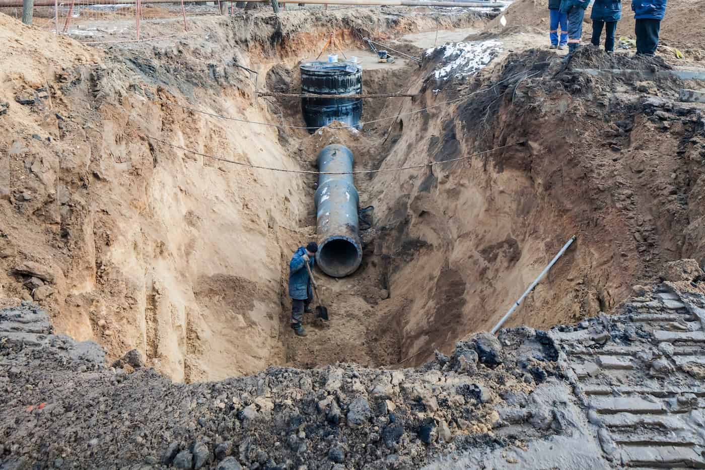Sewer Pipe In The Trench . Urban Construction Of A Trench In The Ground During The Repair Of Water And Sewer Pipes Is Fenced.