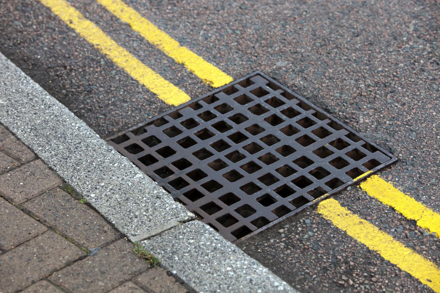 Street Drain Over Double Yellow Line On Street