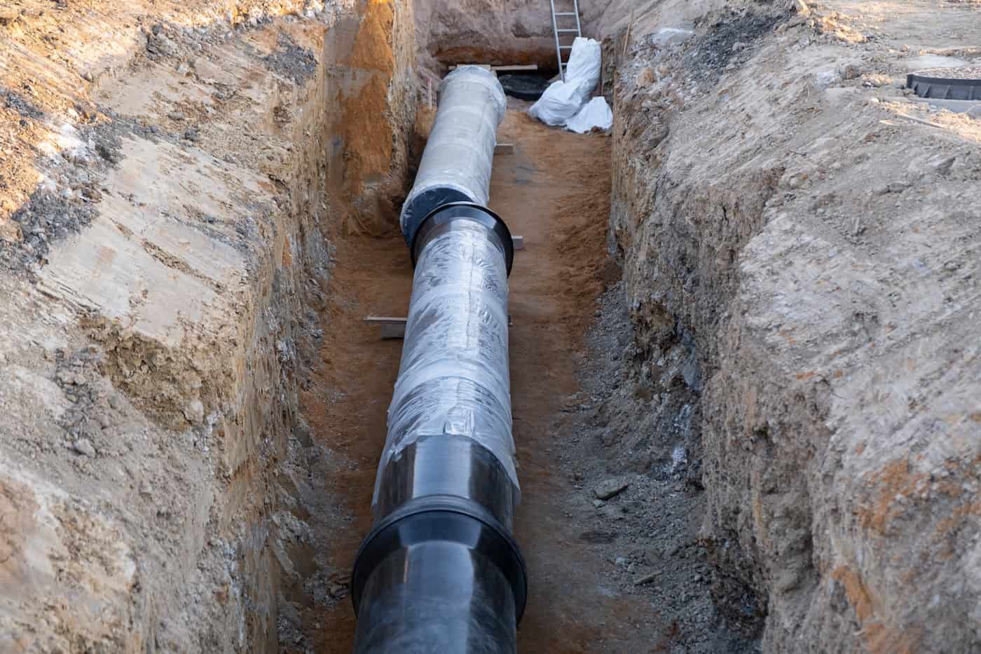 Digged Heating Pipes In A Construction Site. Install Underground Heating System Of Apartments , Water Main Or Sanitary Sewer.