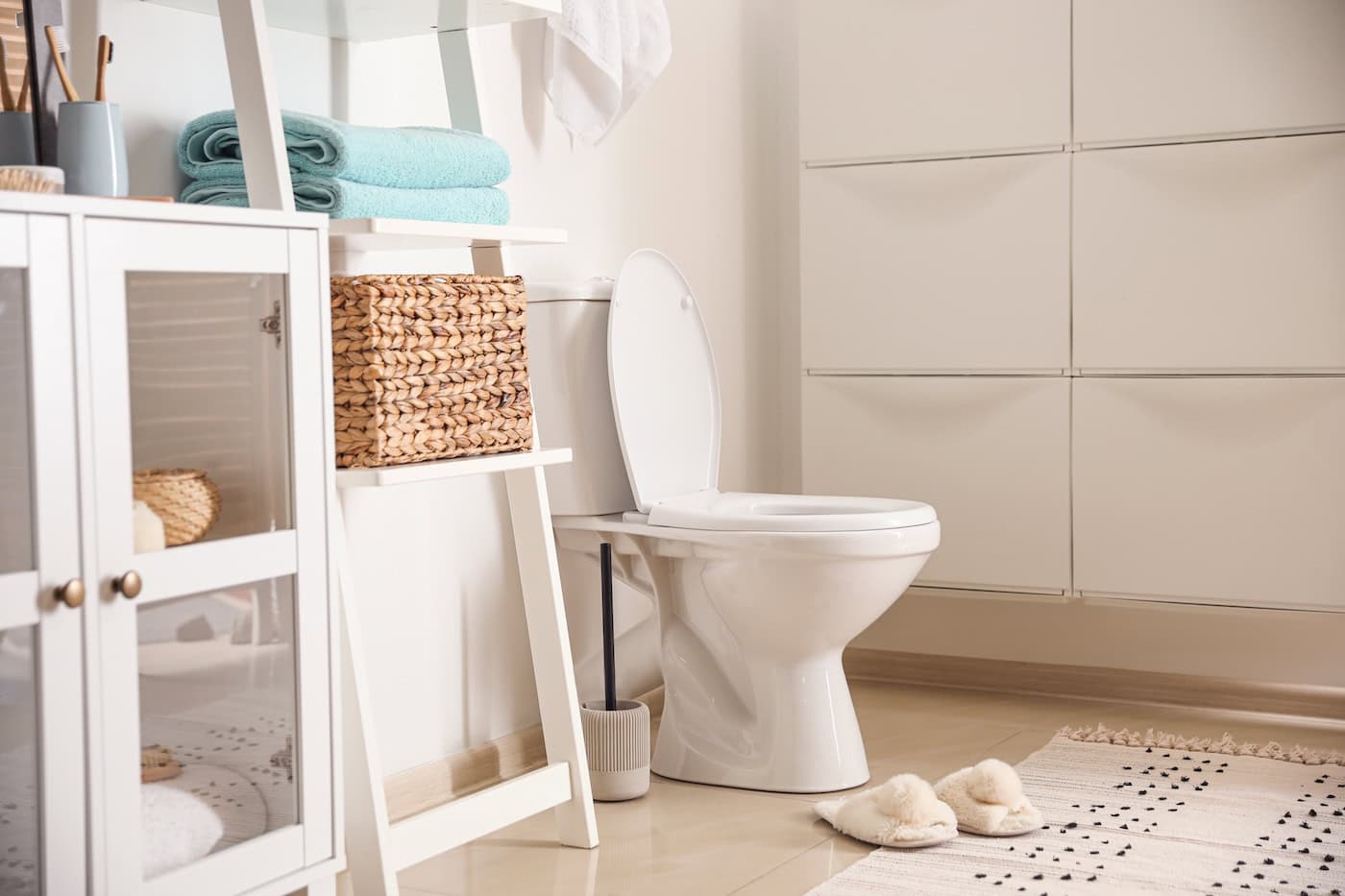 Modern Toilet Bowl Near White Wall In Bathroom