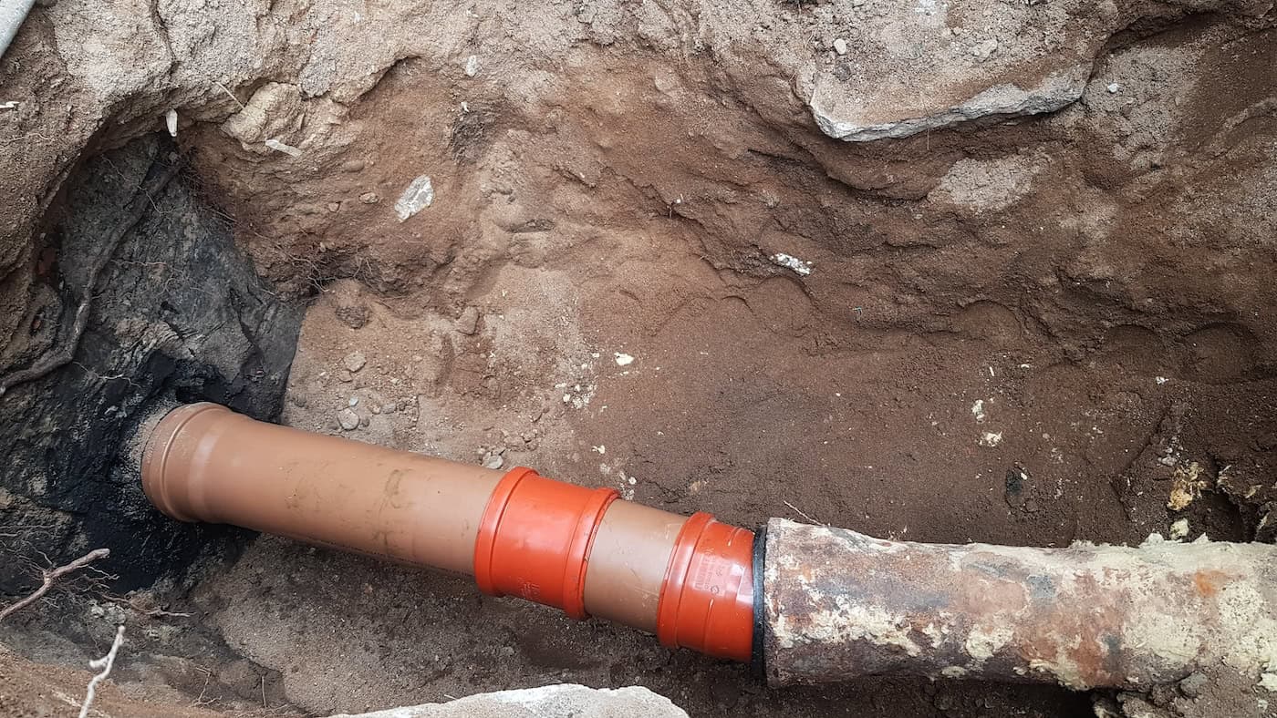 The Sewer Pipe Burst. A Dug Hole For The Repair Of Sewer Pipes. Care And Maintenance In A Private House.