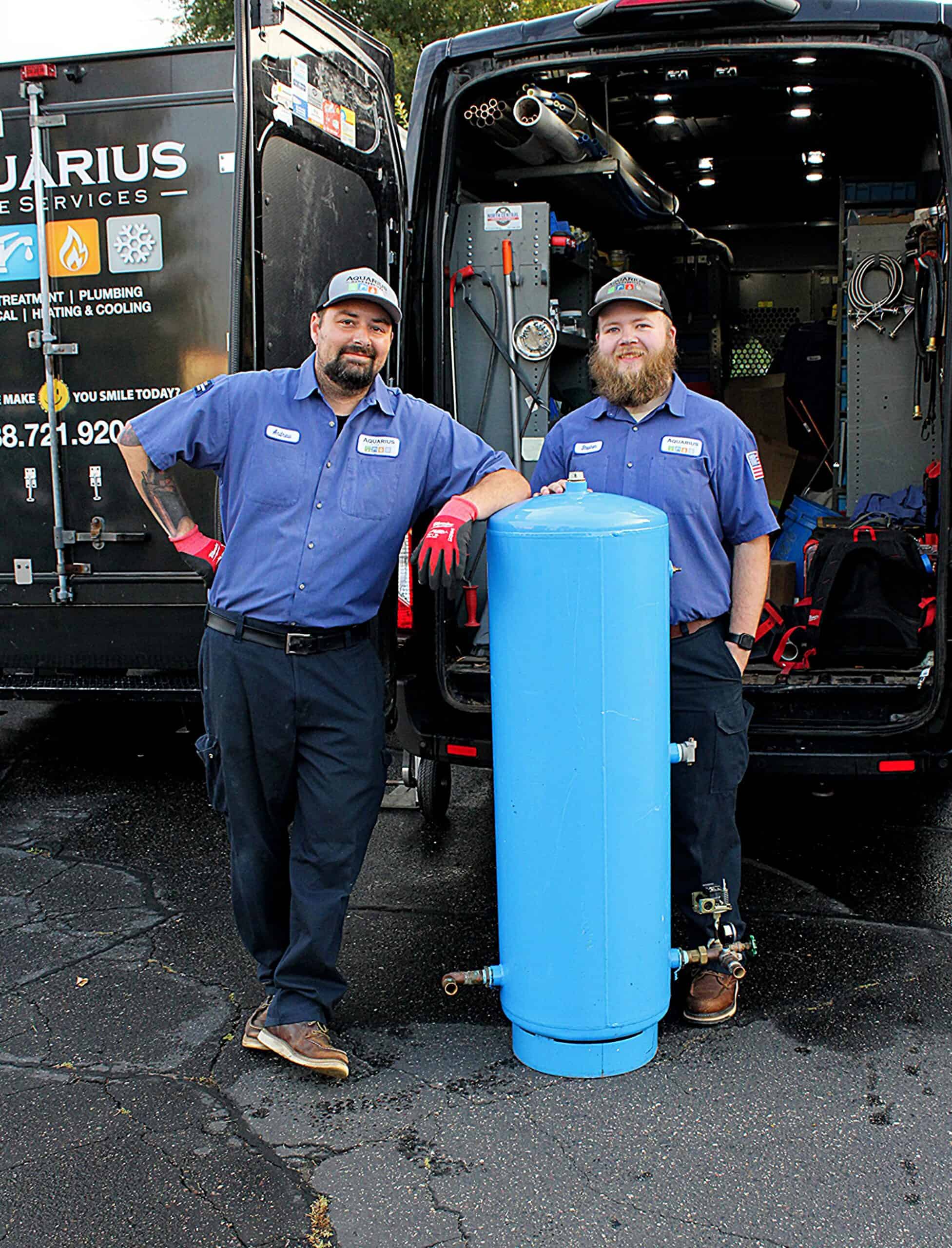 plumbers with a water pressure tank