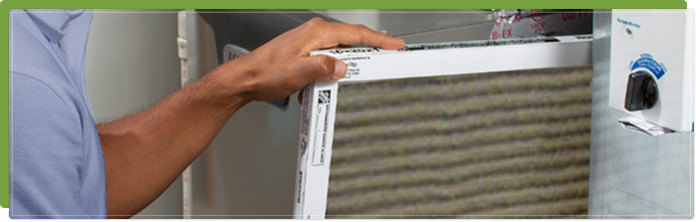 HVAC technician replacing an air quality filter