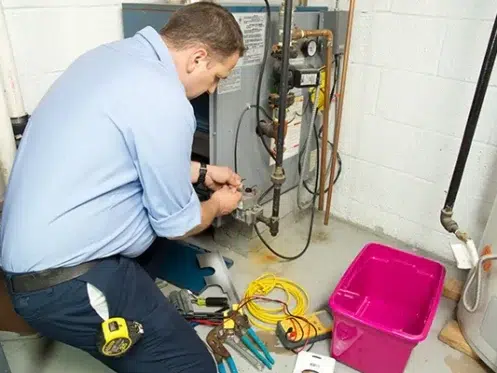 hvac-tech-working-on-a-furnace