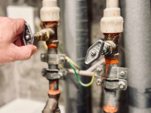 Person shutting off a water valve