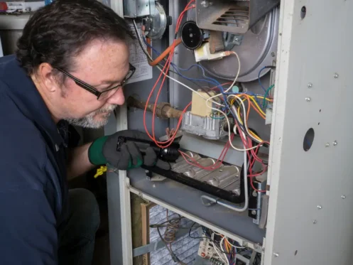 Technician repairing a furnace